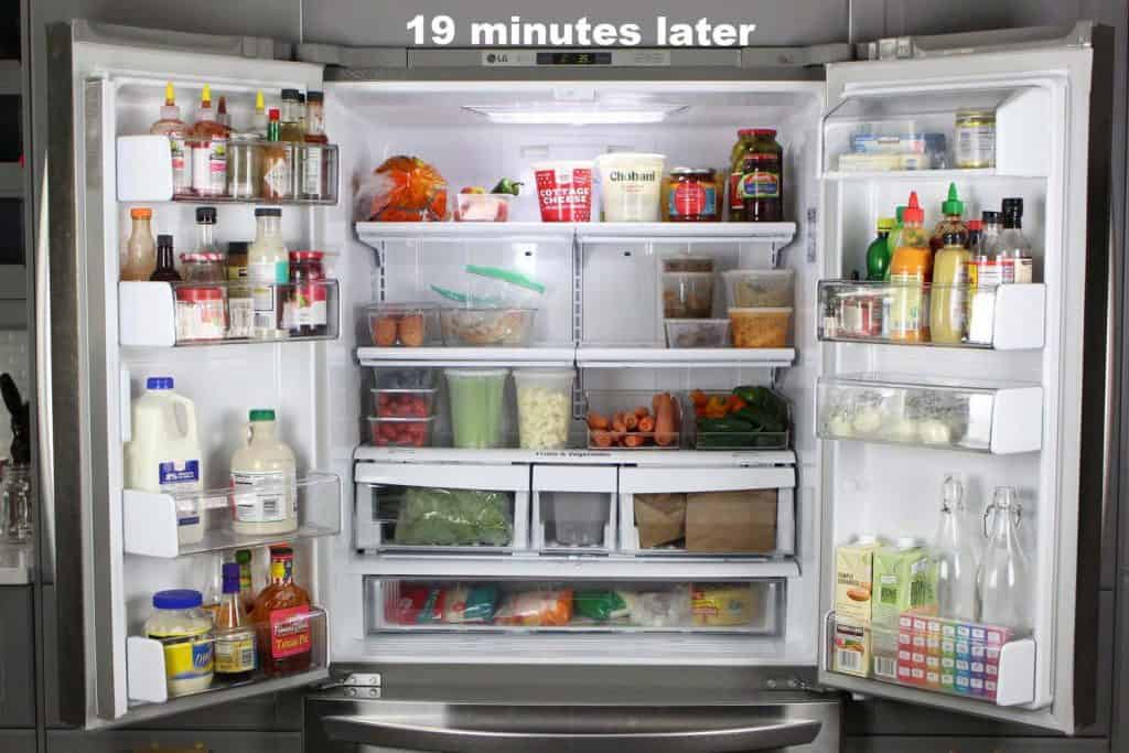 Open double door refrigerator with organized food.