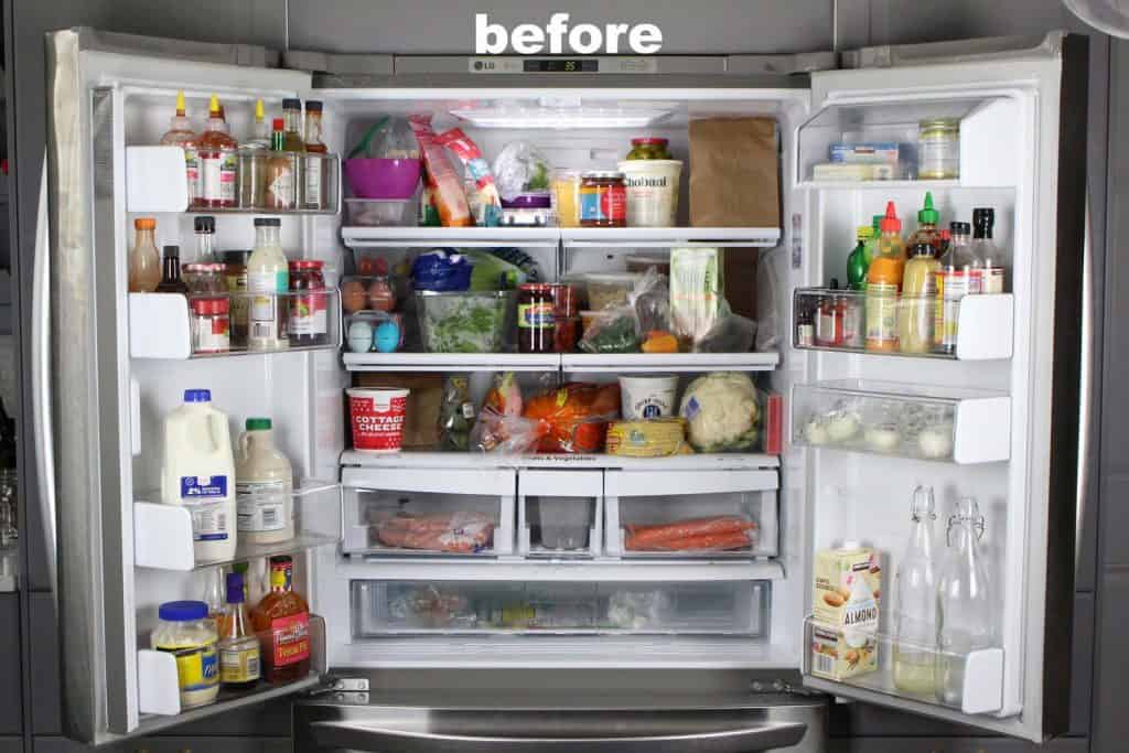 Open double door refrigerator with disorganized food.