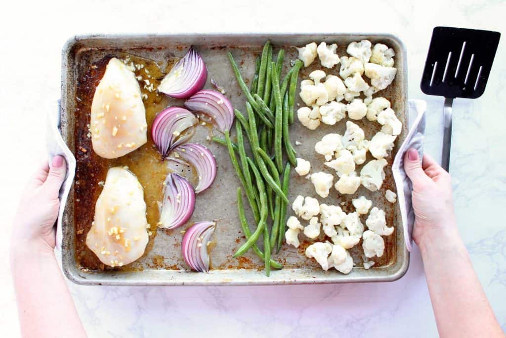 Onions, beans, cauliflower and chicken on sheet pan.