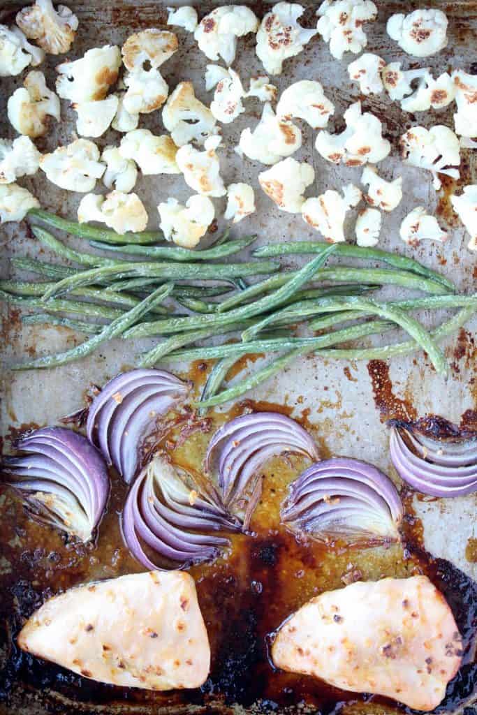 Onions, beans, cauliflower and chicken on sheet pan.