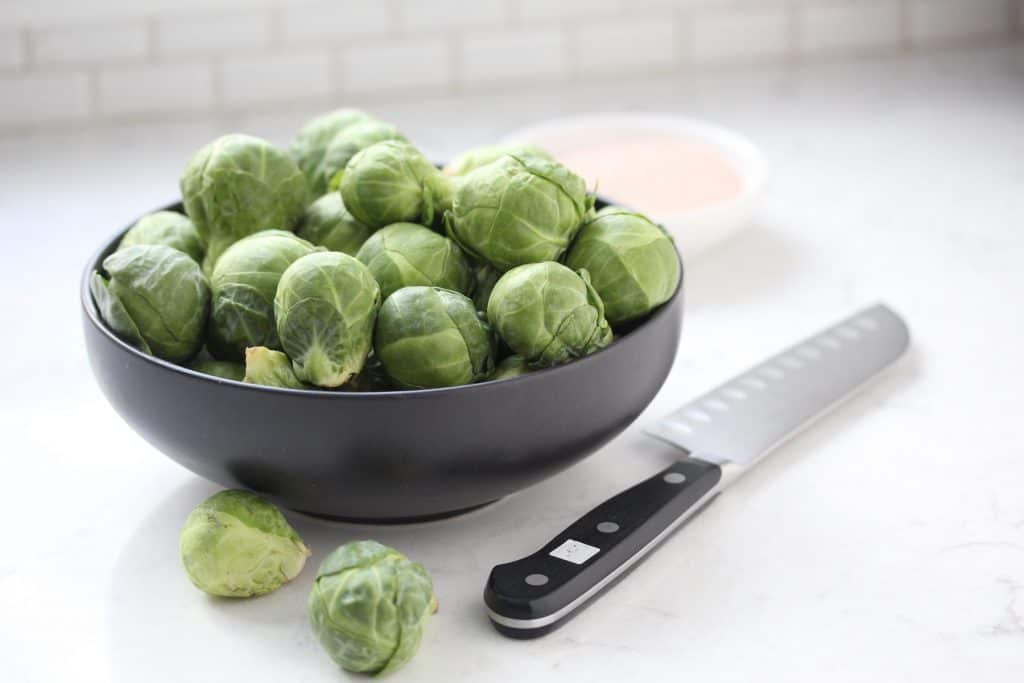 Brussels sprouts in grey bowl.