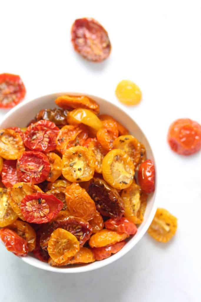 Slow roasted cherry tomatoes in white bowl.