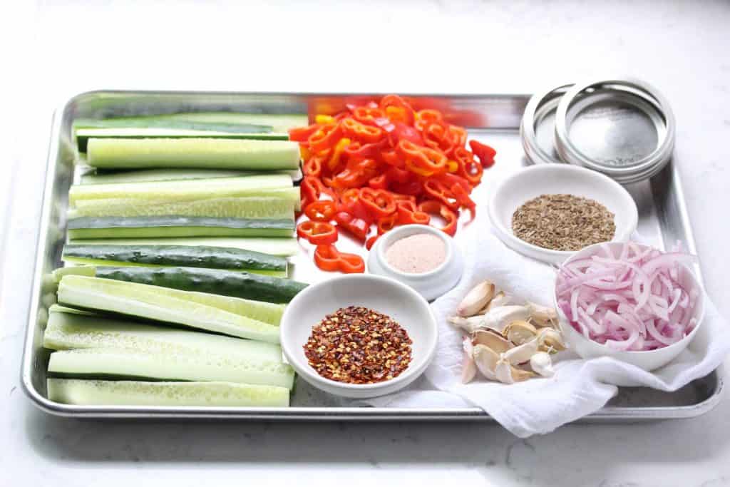 Cucumbers, peppers and spices on sheet pan.