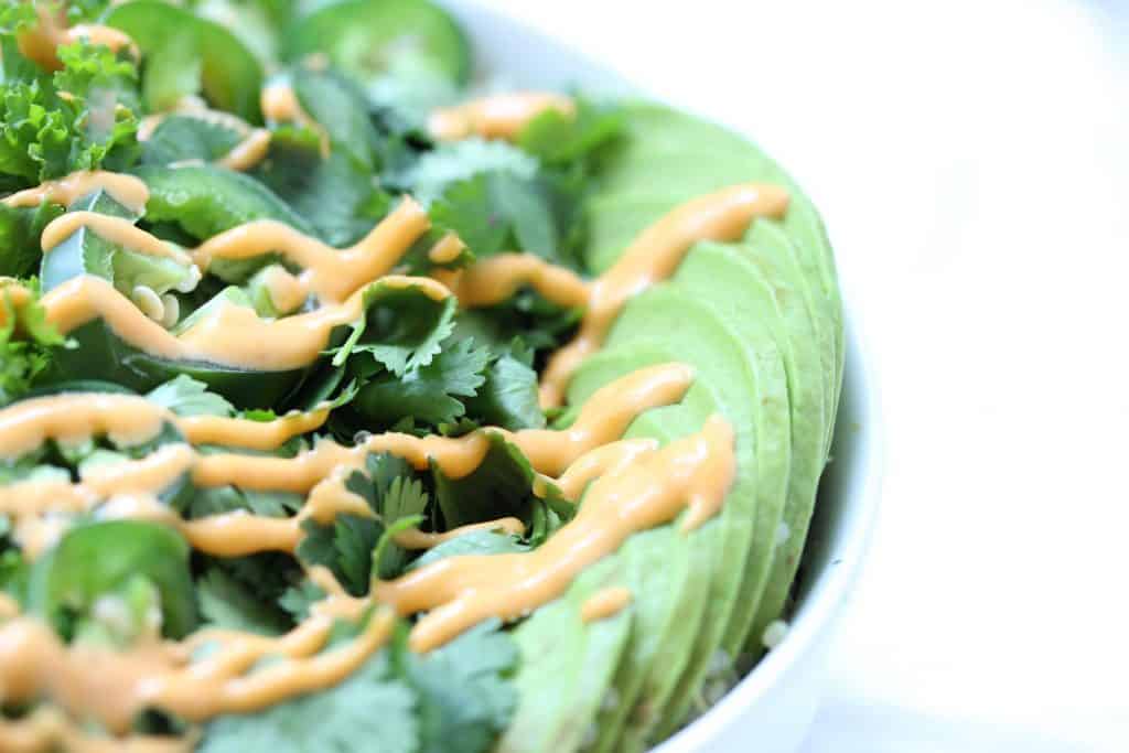 Greens and avocado drizzled with spicy mayo.