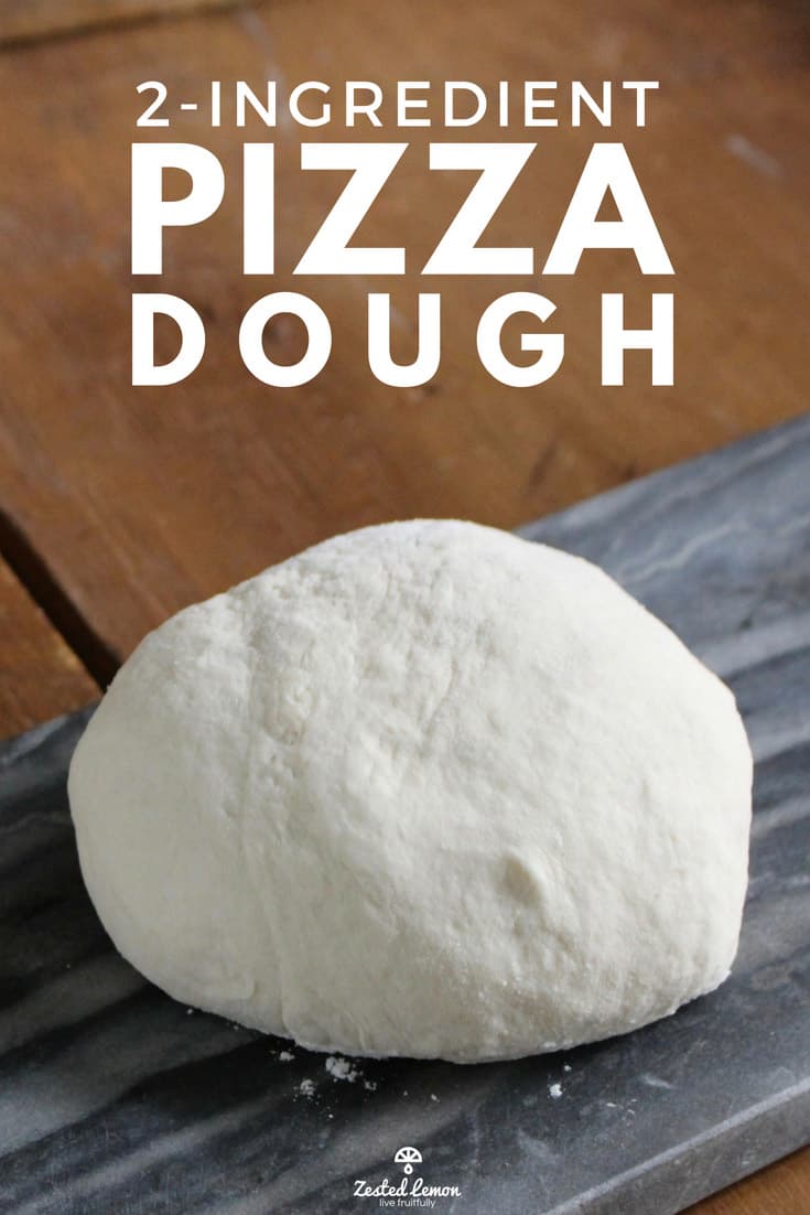 Pizza dough on grey serving platter.